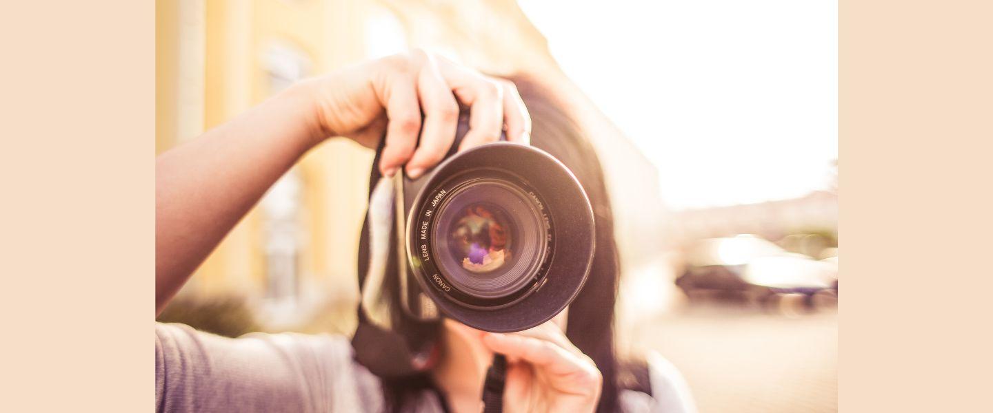 Woman holding up a camera